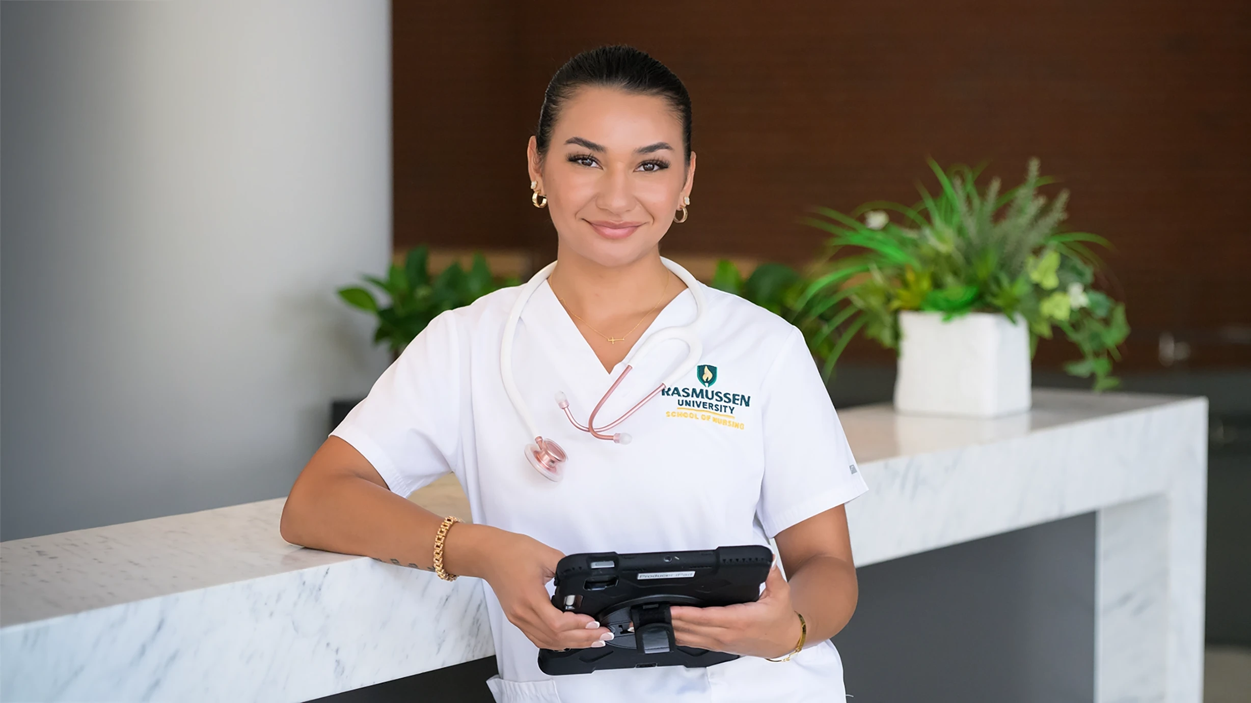 Rasmussen University nursing student in branded scrubs — official Rasmussen photo